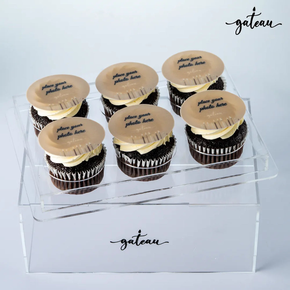 Box of six personalized cupcake gifts with chocolate base and customizable photo toppers from Gateau Gourmet Cafe