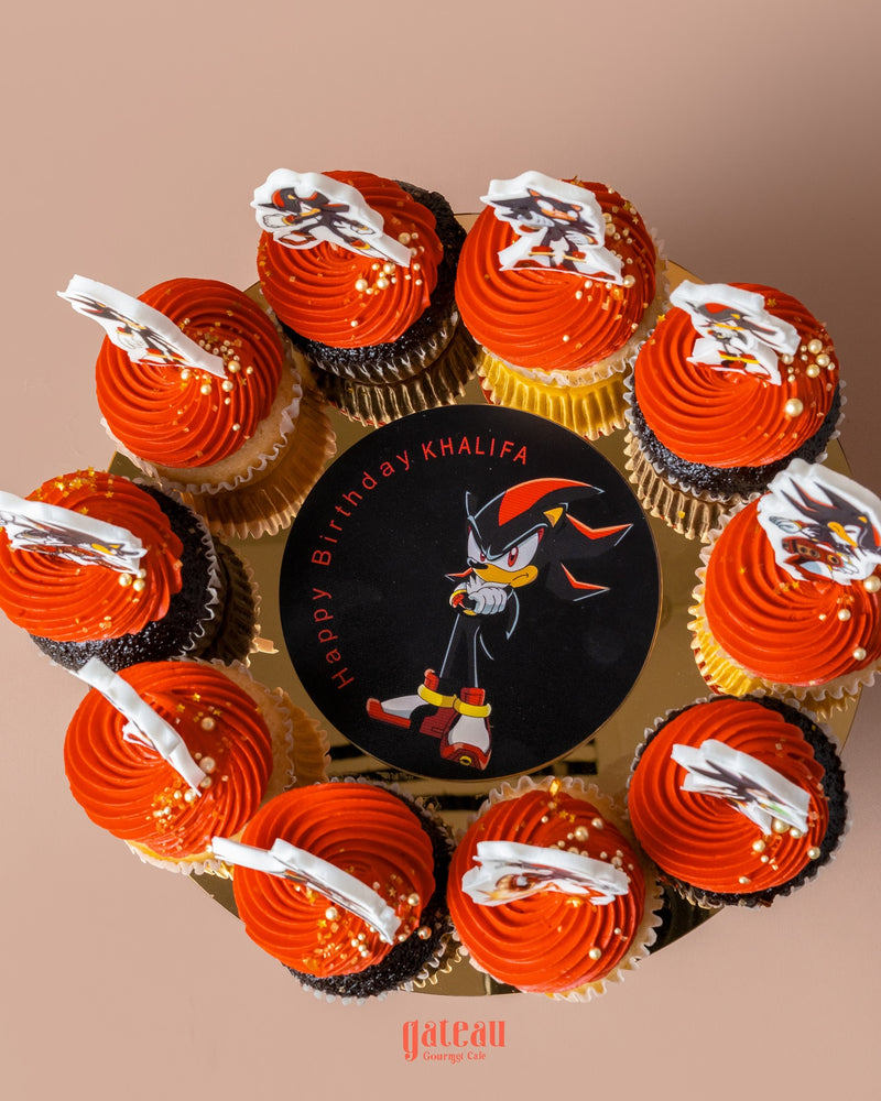Personalized fondant cake designs featuring a birthday cake with Sonic character and matching cupcakes with orange frosting