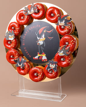 Personalized fondant cake designs featuring red glazed donuts and a custom Sonic-themed birthday centerpiece