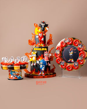 Personalized fondant cake designs featuring cartoon characters with matching themed cupcakes and cookies by Gateau Gourmet Cafe