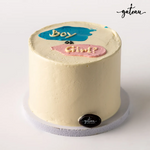 Pink and blue reveal cake with playful question marks for baby announcement celebrations