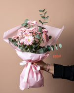 Bouquet of Pink Gerbera Flowers wrapped in pink paper for elegant gifting