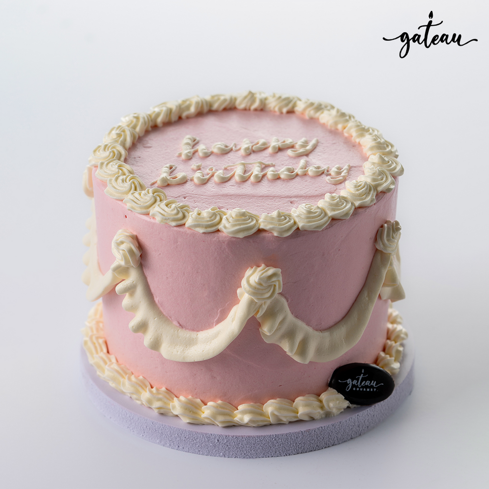 Pink white curtain birthday cakes with decorative frosting and happy birthday inscription on top