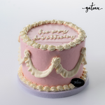 Pink white curtain birthday cakes with decorative frosting and happy birthday inscription on top