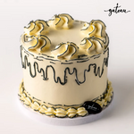 Delicious plain celebration cake from Gateau Gourmet Cafe with elegant frosting and swirls