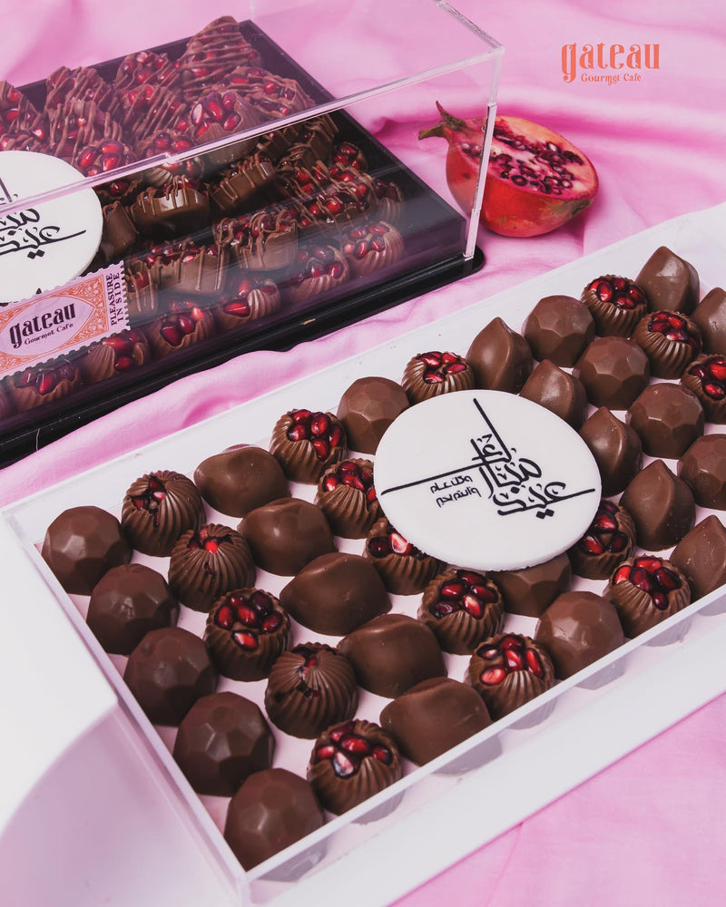 Gateau Gourmet Cafe pomegranate chocolate set in a clear box, featuring assorted chocolate treats with pomegranate pieces