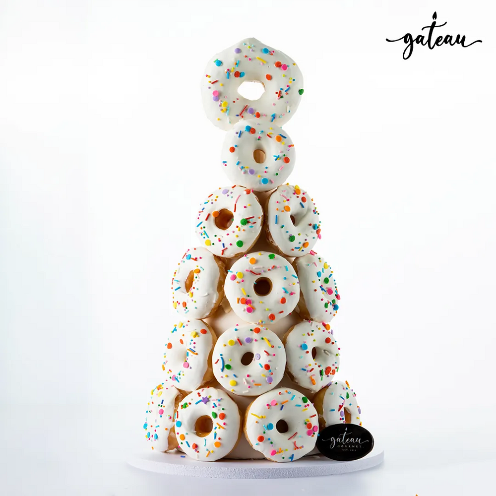 Premium donut tower with white icing and colorful sprinkles from Gateau Gourmet Cafe