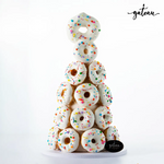 Premium donut tower with white icing and colorful sprinkles from Gateau Gourmet Cafe