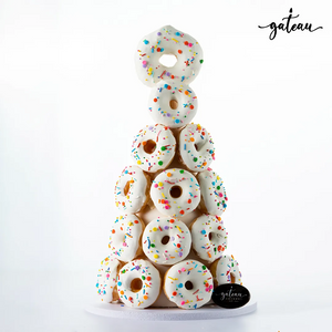Premium donut tower with white icing and colorful sprinkles from Gateau Gourmet Cafe