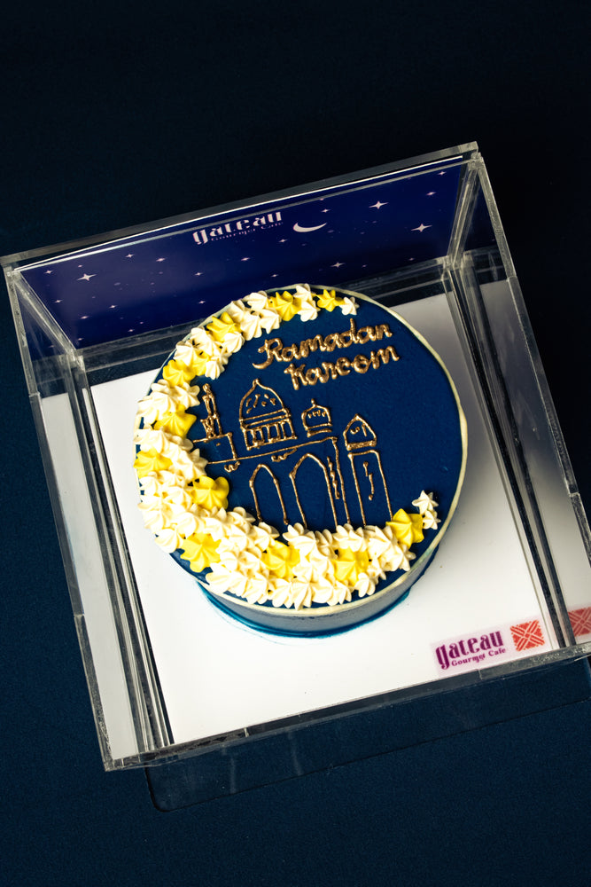 Gateau Gourmet Cafe Ramadan celebration cake with blue icing and gold mosque design topped with white and yellow flowers