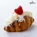 Gateau Gourmet Cafe raspberry coconut croissant topped with shredded coconut and a fresh raspberry