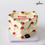 Romantic custom cake for couples by Gateau Gourmet Cafe heart-shaped with white frosting and red rose decorations