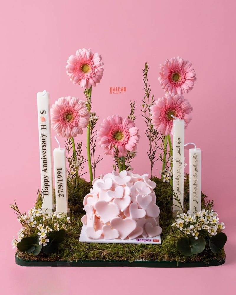 Romantic heart cake arrangement with pink flowers and decorative candles by Gateau Gourmet Cafe