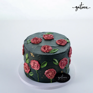 Elegant black rose-engrave cake adorned with pink icing roses and green leaves from Gateau Gourmet Cafe