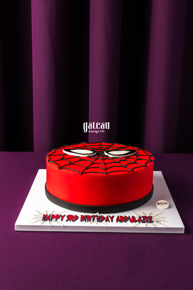 Spiderman theme cake for kids by Gateau Gourmet Cafe featuring red and black web design