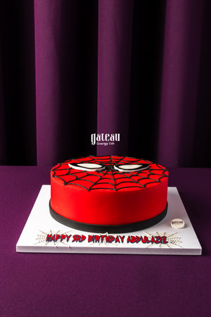 Spiderman theme cake for kids by Gateau Gourmet Cafe featuring red and black web design
