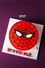 Spiderman theme cake for kids by Gateau Gourmet Cafe with red web design and black spider eyes