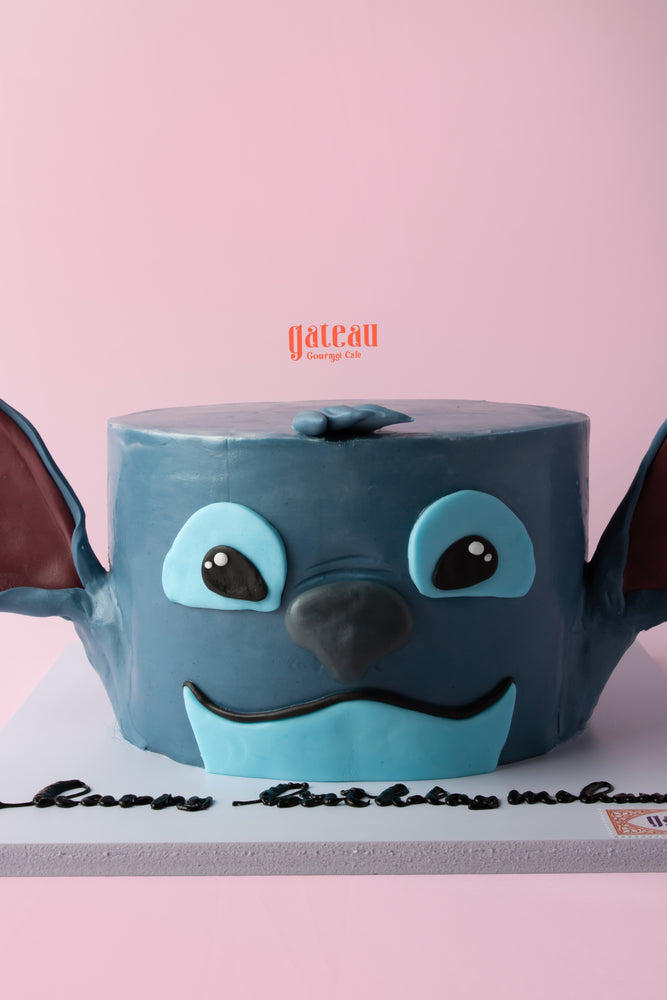 Stitch themed cake shaped like Stitch's face, perfect for birthday celebrations at Gateau Gourmet Cafe