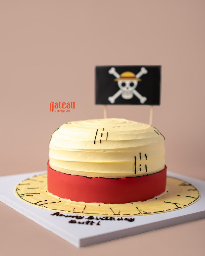 Straw Hat of One Price Monkey D Luffy Cake by Gateau Gourmet Cafe with yellow and red frosting and pirate flag decoration