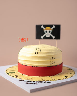 Straw Hat of One Price Monkey D Luffy Cake by Gateau Gourmet Cafe with yellow and red frosting and pirate flag decoration