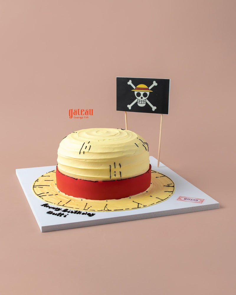 Straw Hat of One Price Monkey D Luffy Cake by Gateau Gourmet Cafe shaped like iconic yellow straw hat with red band and pirate flag decoration