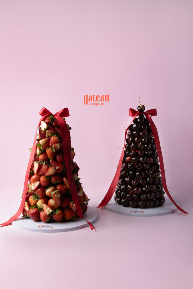 Strawberry and cherry dessert tower with fresh fruits topped with elegant ribbons