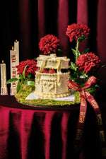 Strawberry white cake arrangement by Gateau Gourmet Cafe decorated with red flowers and intricate icing designs