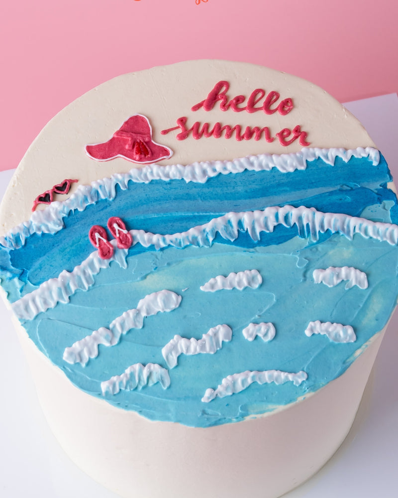 Summer celebration cake by Gateau Gourmet Cafe with ocean waves and hello summer decoration