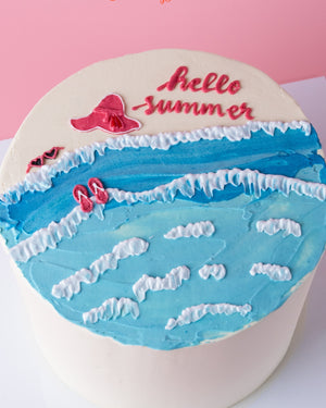 Summer celebration cake by Gateau Gourmet Cafe with ocean waves and hello summer decoration