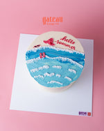 Gateau Gourmet Cafe summer celebration cake with ocean waves, flip flops, sun hat, and hello summer text