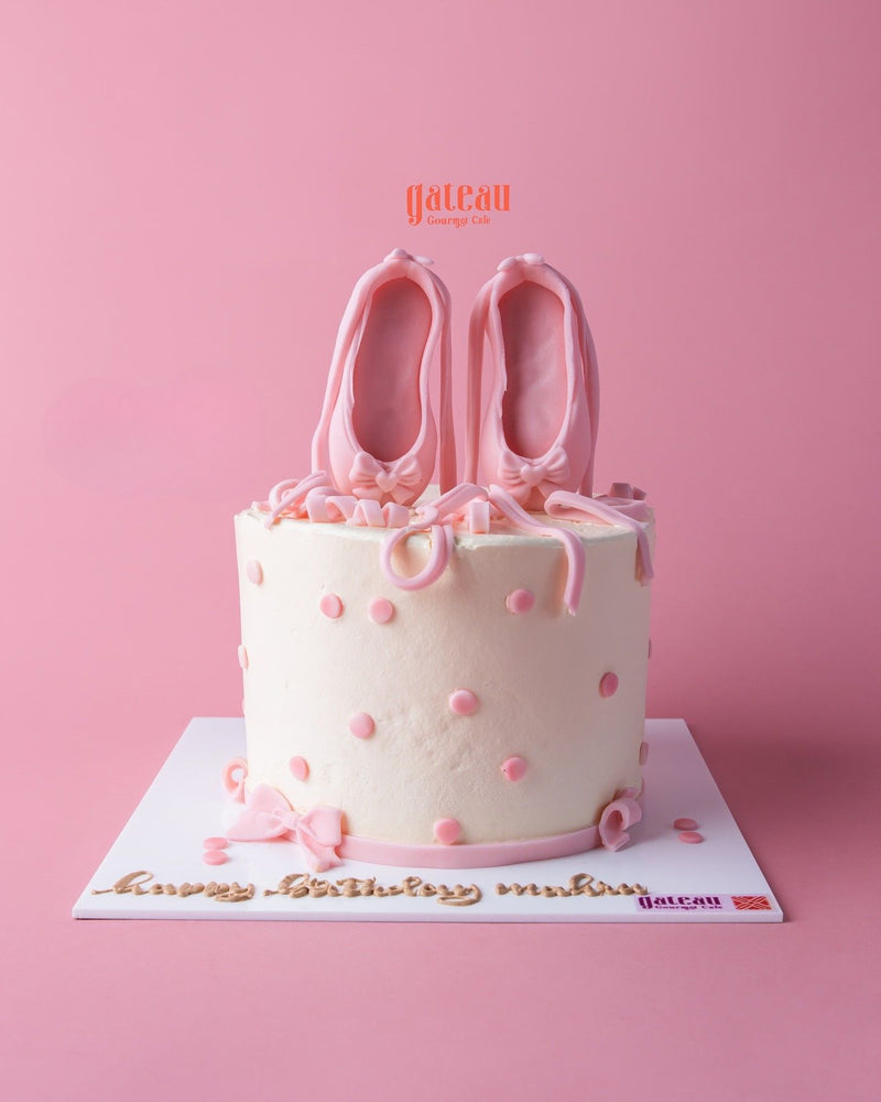 Tailored birthday cake for her featuring pink ballet shoes and decorative polka dots