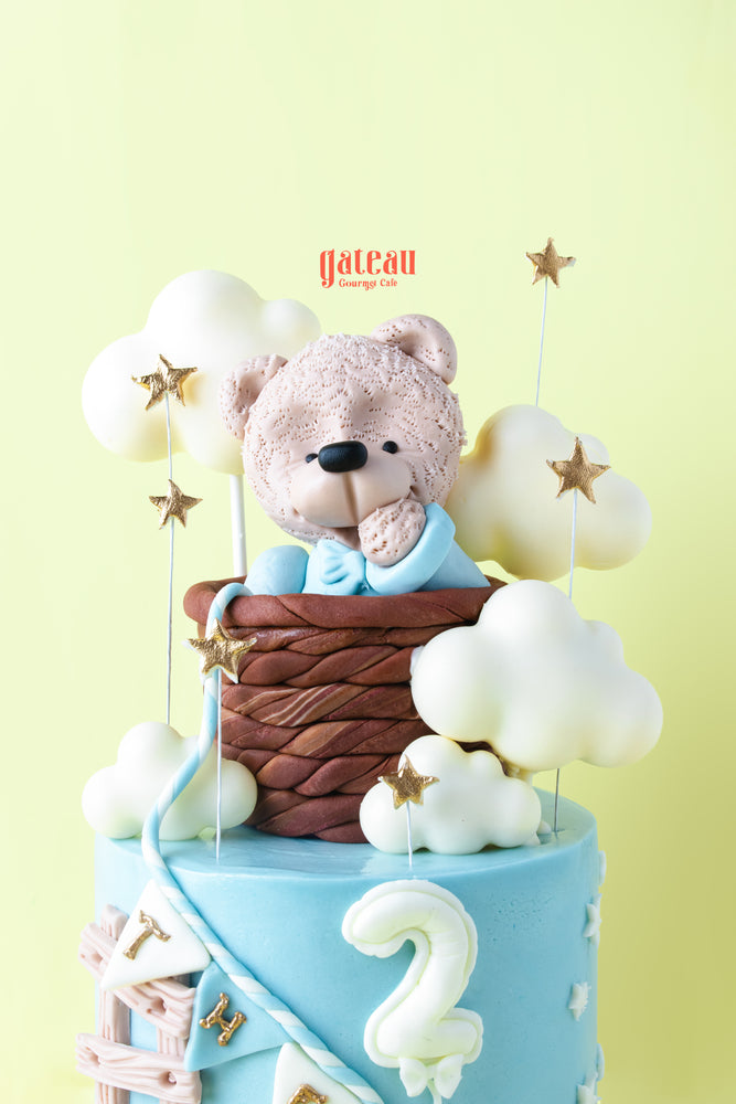 Teddy bear birthday cake from Gateau Gourmet Cafe with clouds and stars for a child's celebration