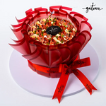 Gateau Gourmet Cafe tulip flower cake with red decorative wrapping and ribbon on white board