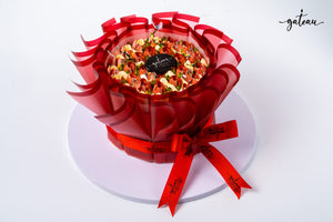 Gateau Gourmet Cafe tulip flower cake decorated with delicate edible flowers and wrapped in red translucent paper