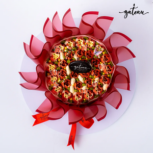 Gateau Gourmet Cafe tulip flower cake with intricate floral design and decorative red wrapping