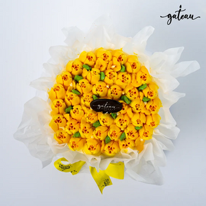 Gateau Gourmet Cafe tulip flower cake with bright yellow floral design and green leaves wrapped in white paper
