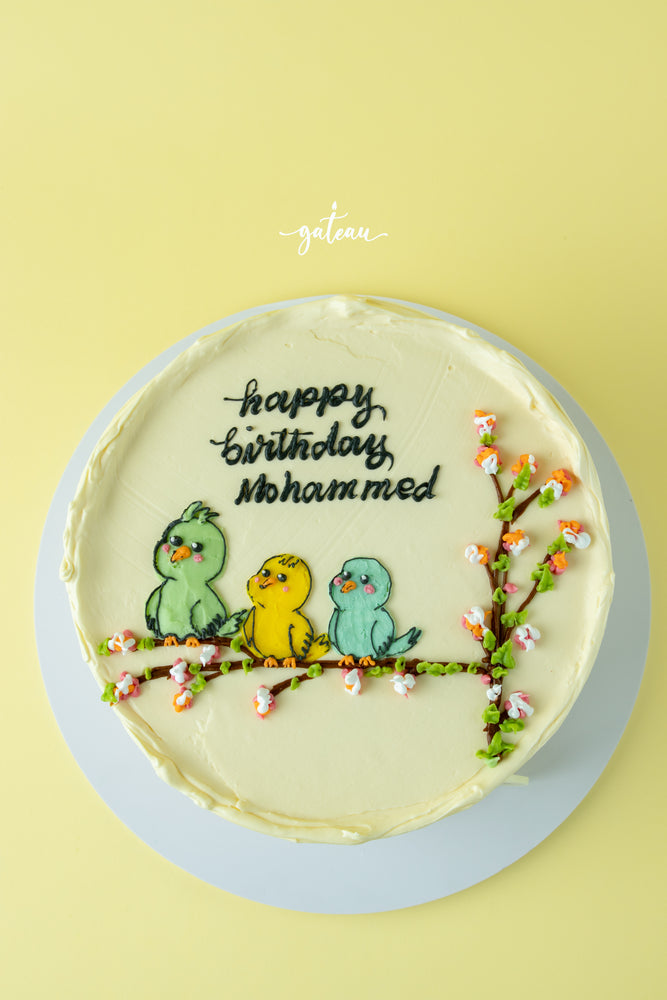 Gateau Gourmet Cafe Tweety bird birthday cake with three colorful birds and cherry blossom decorations