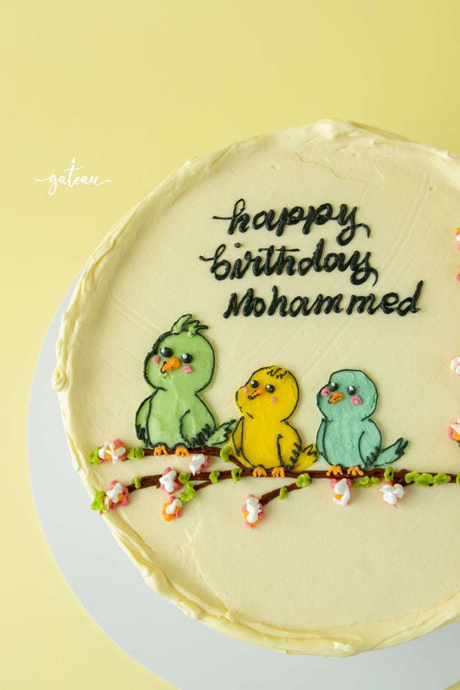 Tweety bird birthday cake with colorful bird designs and happy birthday Mohammed message