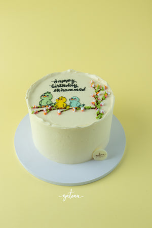 Gateau Gourmet Cafe tweety bird birthday cake with three colorful birds and floral branch decoration
