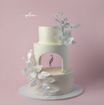 Gateau Gourmet Cafe undyed white wedding cake with three tiers and delicate white floral decorations
