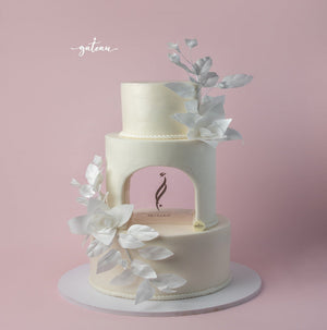 Gateau Gourmet Cafe undyed white wedding cake with three tiers and delicate white floral decorations