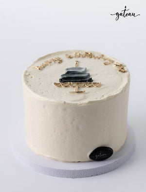 Simple white birthday cake with black and gold decoration showcasing unique birthday cake designs by Gateau Gourmet Cafe