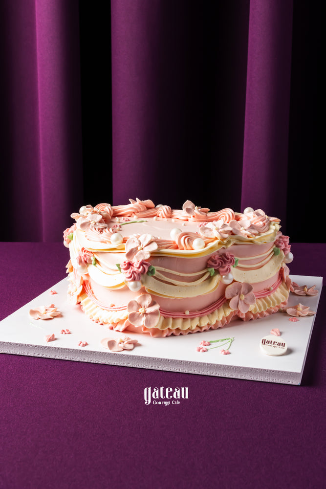 Unique birthday cakes for delivery by Gateau Gourmet Cafe with pink floral frosting and elegant design