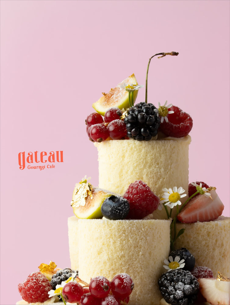 Vanilla fruit tower cake with fresh berries and edible flowers from Gateau Gourmet Cafe
