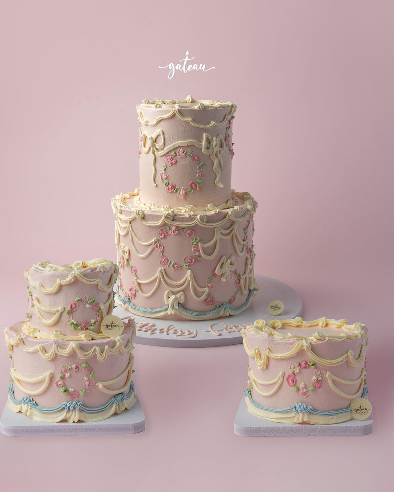 Elegant Vintage Buttercream Drape Cake with intricate floral decorations and pastel colors
