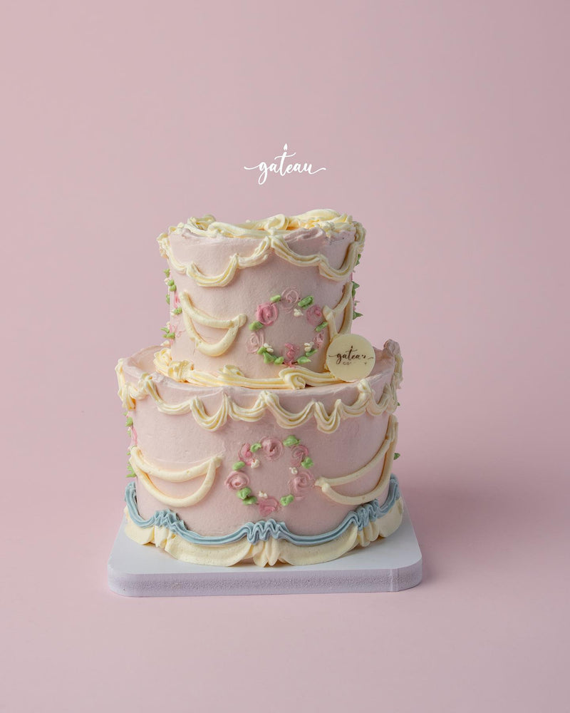 Elegant Vintage Buttercream Drape Cake decorated with floral accents from Gateau Gourmet Cafe