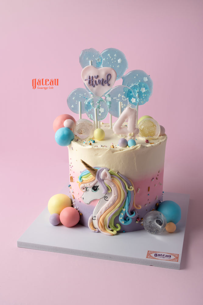 Whimsical unicorn cake for kids decorated with pastel colors and playful elements from Gateau Gourmet Cafe