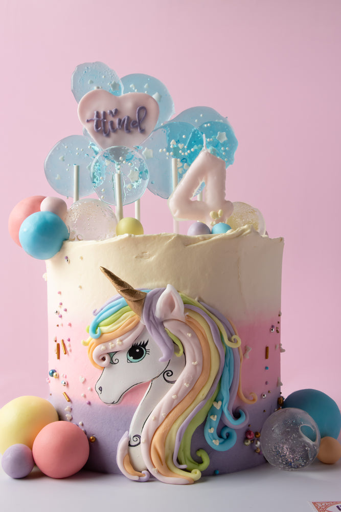 Whimsical unicorn cake for kids with rainbow colors and a unicorn design for birthday celebrations