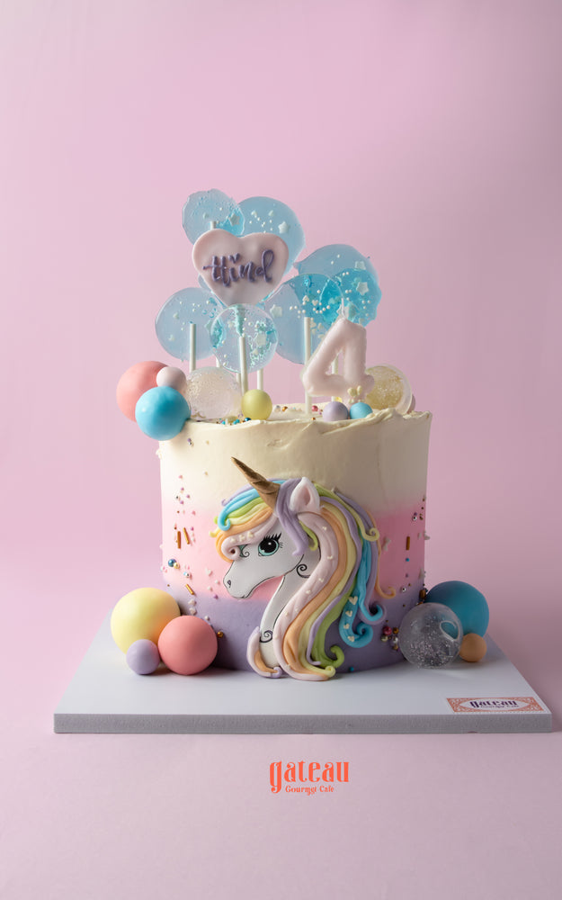 Whimsical unicorn cake for kids with colorful decorations and a playful design from Gateau Gourmet Cafe
