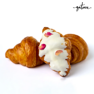 Gateau Gourmet Cafe white chocolate croissant with rose petals and two plain croissants on white background